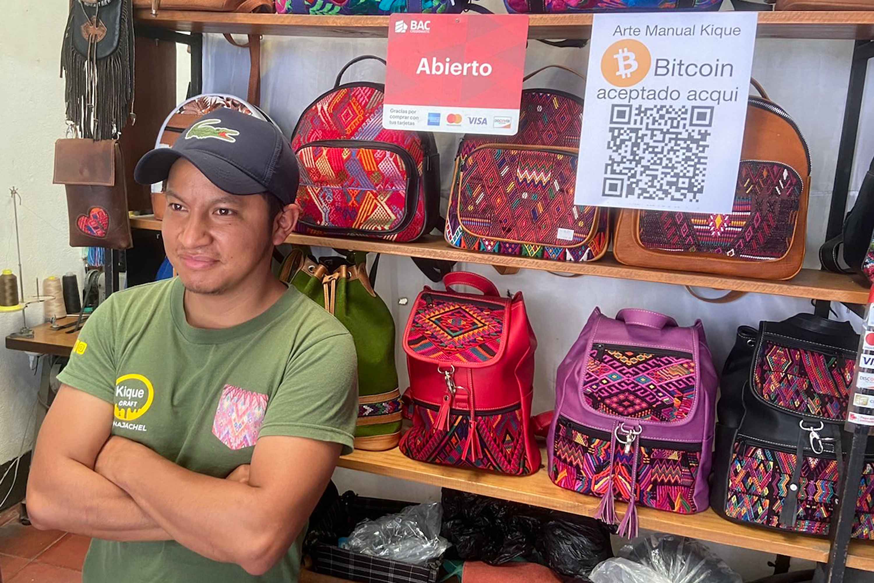 Artisan Enrique González learned to work leather form his father and now sells to tourists at his shop in Panajachel. Two years of the pandemic hit his business hard, and he's now looking for new sources of revenue. Bitcoin Lake founder Patrick Melder convinced him to install a QR code in his store to take tips in bitcoin, though he hasn't yet dared to take full payments. Photo: Roman Gressier/El Faro