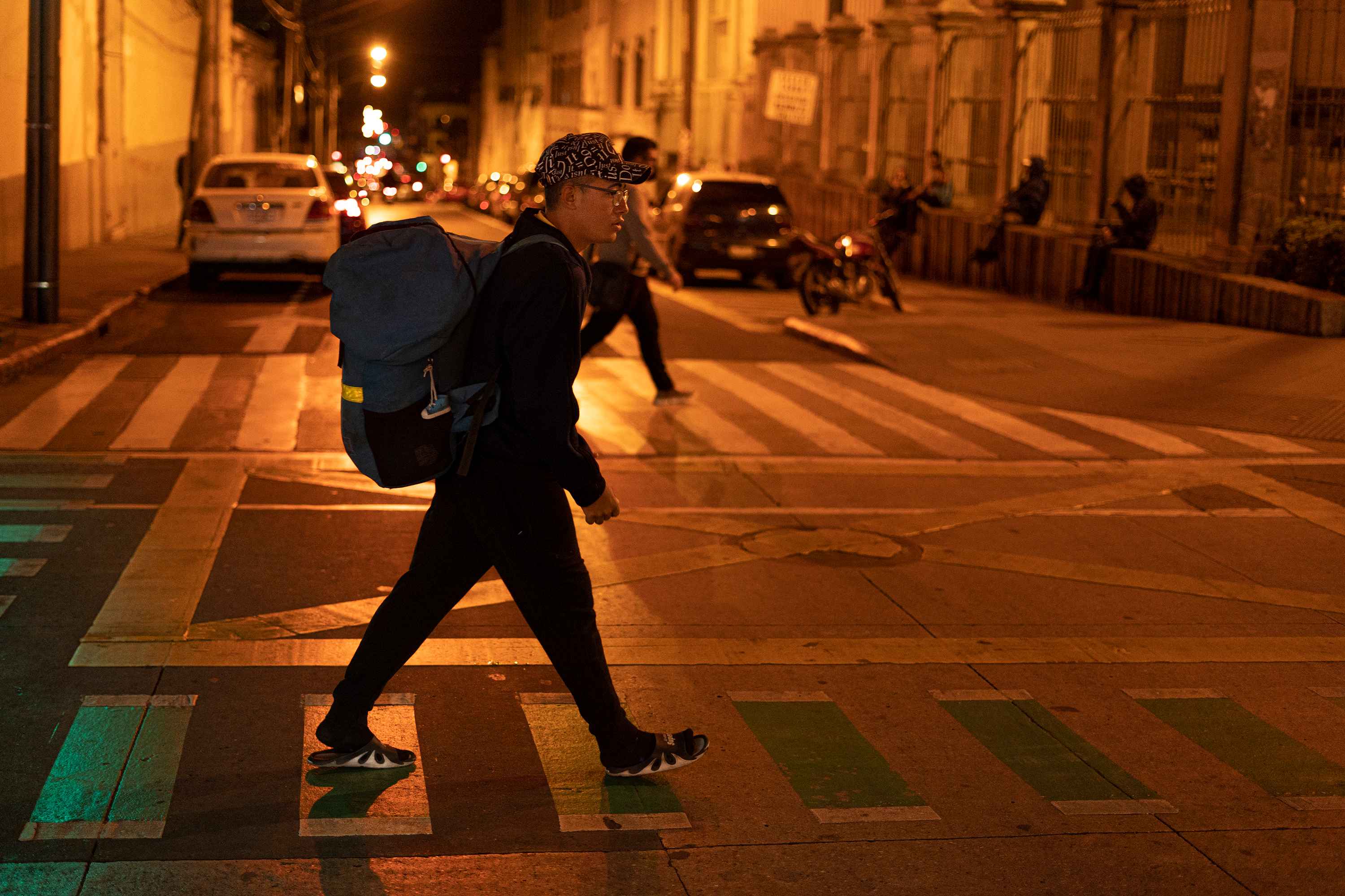 Juan walks down Sixth Avenue toward his hotel after a long day of work in the center of Guatemala City. Photo: Víctor Peña/El Faro