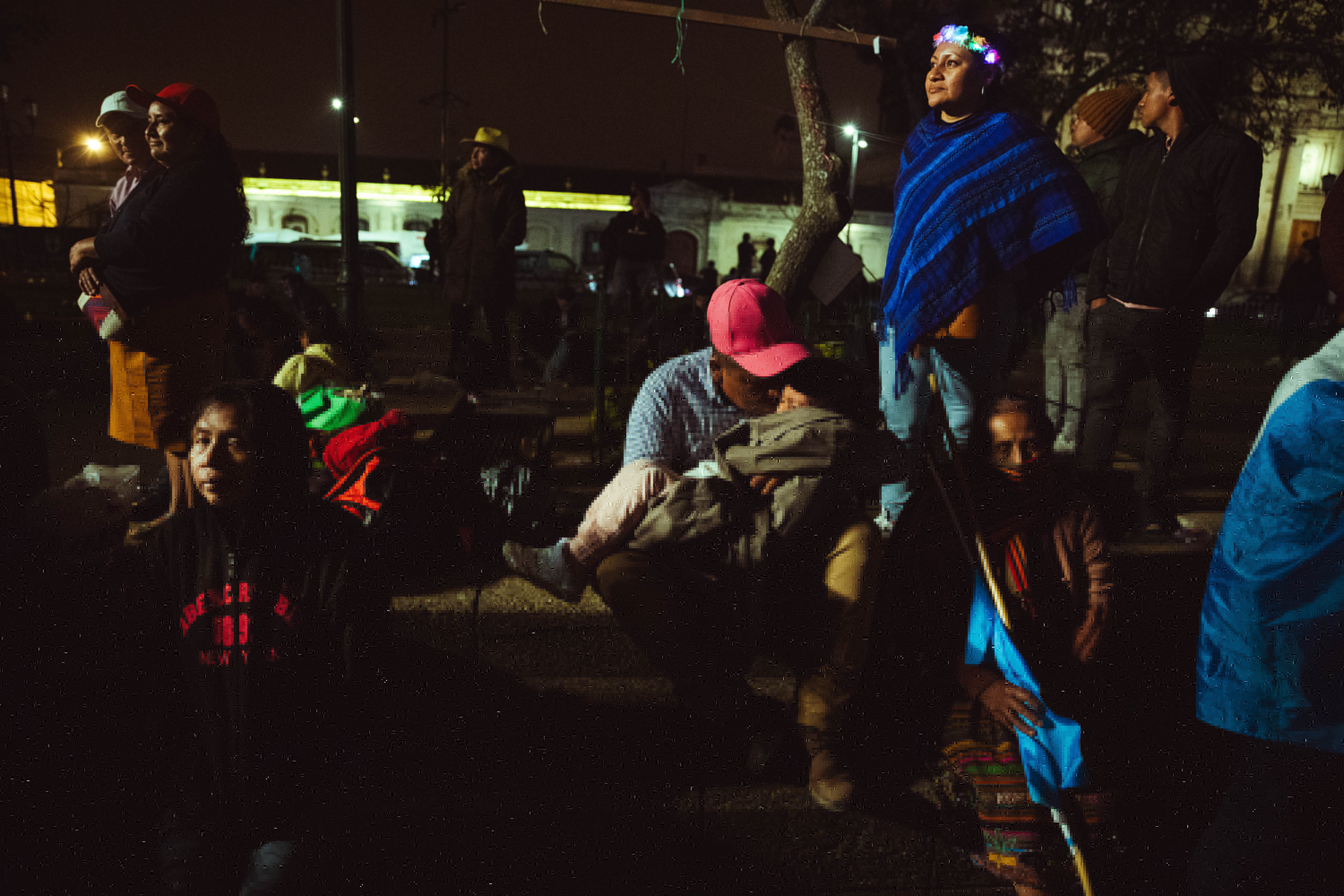 The Domínguez family spent 24 hours in the Constitutional Plaza to hear Bernardo Arévalo's inaugural address on Jan. 15, 2024. Joel Domínguez (middle) consoles his crying son in the cold. The family left home in Retalhuleu, along the southwestern coast, on January 13. Photo Carlos Barrera