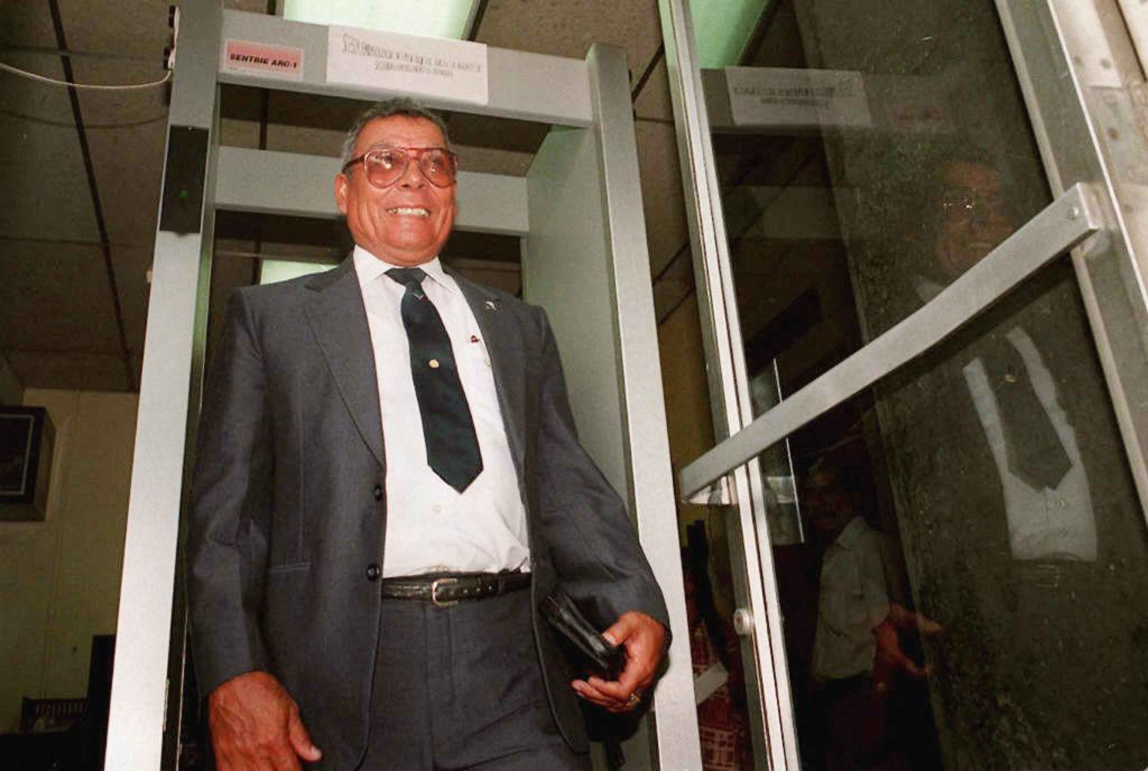 Retired General Benedicto Lucas García, the former chief of the General Staff, passes through a metal detector at the Public Prosecutor's Office in Guatemala City on July 9, 1997, after giving a statement regarding the Dos Erres massacre, in which élite Kaibil commandos murdered around 250 campesinos. One year after the signing of the peace accords, it was the first case in which military leaders were summoned regarding armed conflict-era human rights abuses. Photo Jorge Uzón/AFP