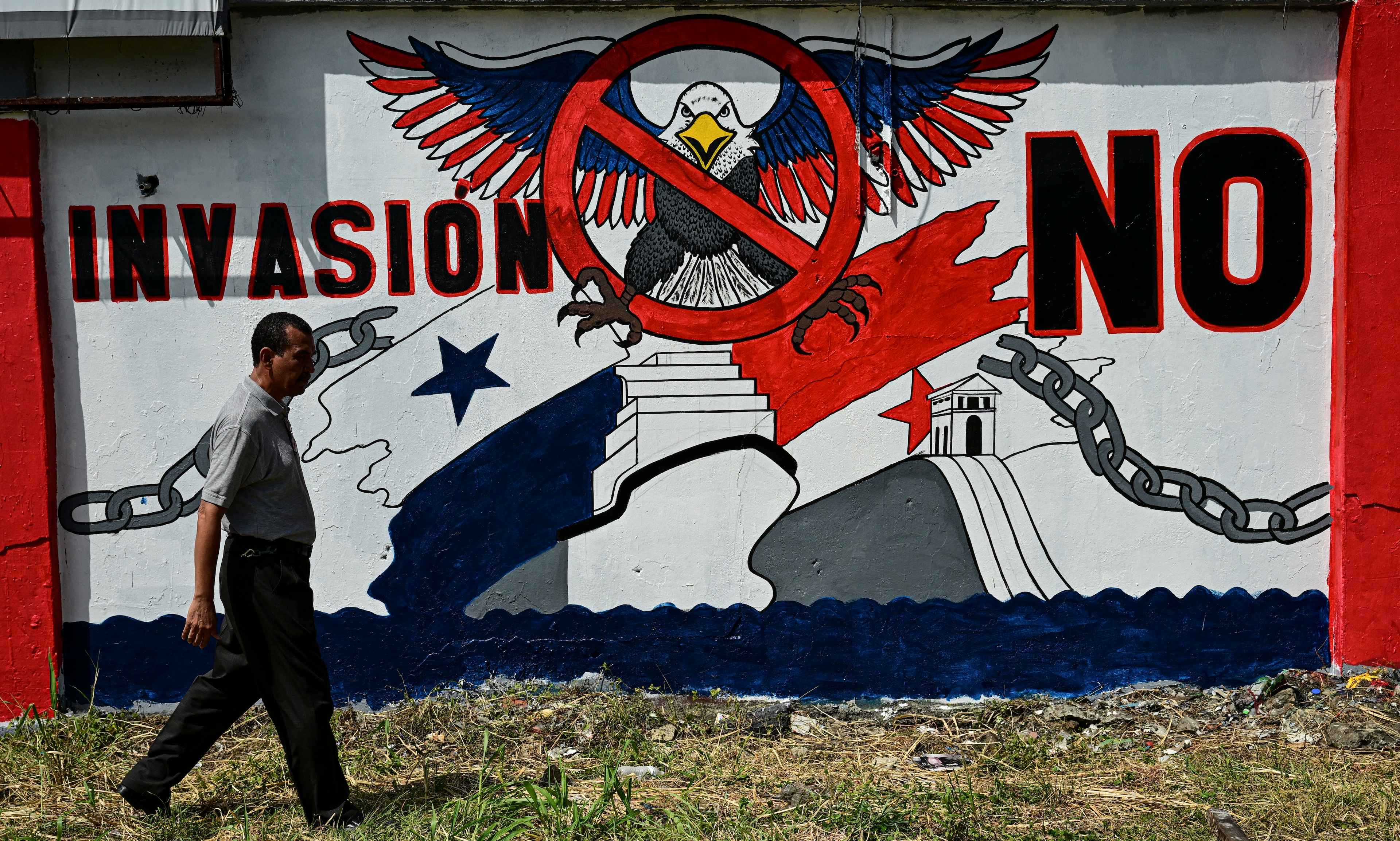 A man walks past a mural that reads “No invasion” in Colón, Panama on Jan. 29, 2025 prior to a visit by U.S. Secretary of State Marco Rubio. Photo Martin Bernetti/AFP