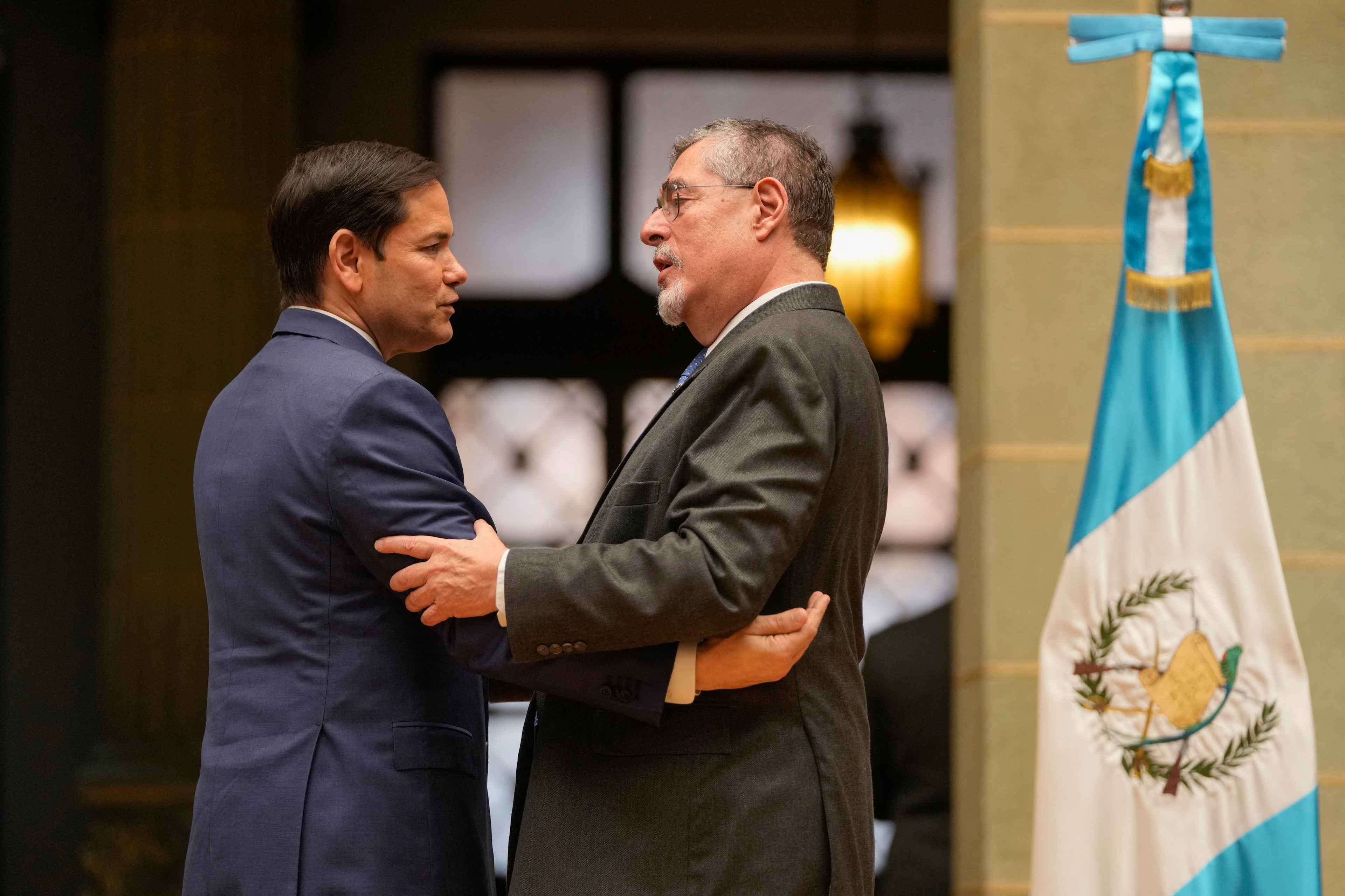 U.S. Secretary of State Marco Rubio (left) embraces Guatemalan President Bernardo Arevalo after a joint news conference at the National Palace of Culture in Guatemala City on Feb. 5, 2025. Arévalo announced that Guatemala will receive 40 percent more deportation flights, while Rubio said that the U.S. Army Corps of Engineers will support the construction of new port infrastructure and other projects. Photo Mark Schiefelbein/Pool/AFP