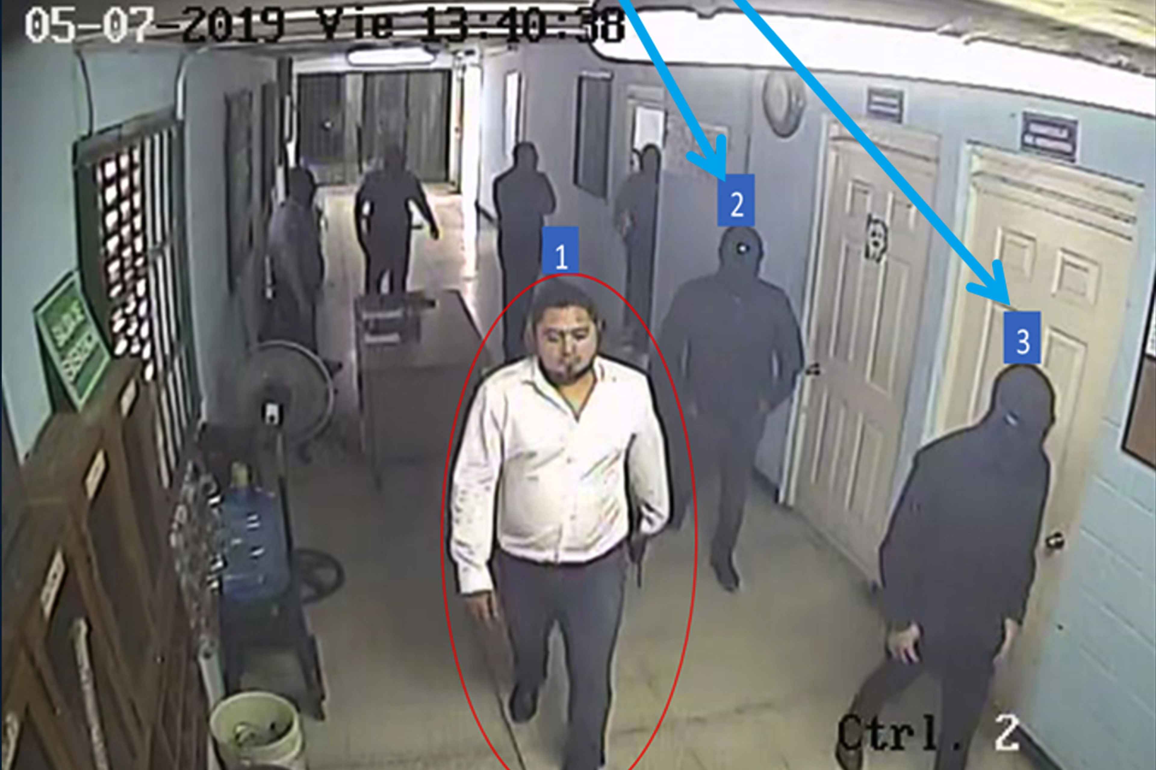 Director of Prisons Osiris Luna accompanies masked men entering supermax prison Zacatecoluca. This image was collected by prosecutors in Operation Cathedral investigating the Bukele administration's covert negotiations with MS-13 and 18th Street for a reduction in homicides and electoral support.